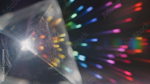 Prism refracting light into spectrum during cinematic close-up with lens flare