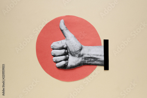 Hand showing thumbs up gesture on paper cutout red circle background