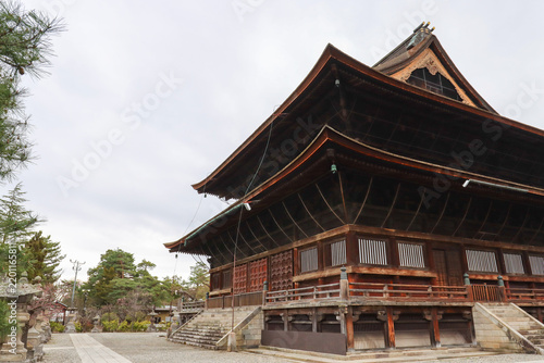 Architectural view of the Hondō, the main worship hall of Zenko-ji Temple, surrounded by historic temple grounds