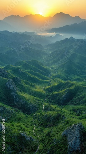 Stunning Sunrise Over Lush Green Mountain Peaks And Rolling Valleys Under Golden Morning Sky