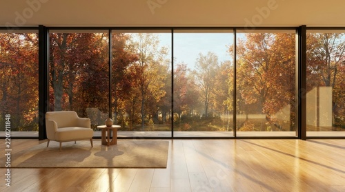 Modern living room with large windows overlooking autumn forest.