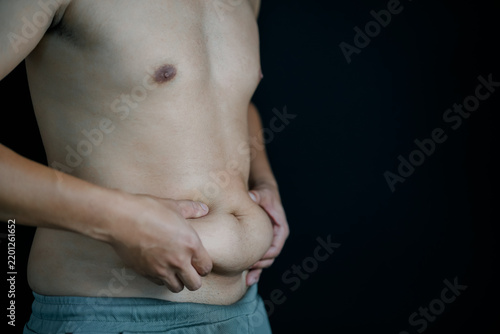 Young Man Experiencing Stomach Pain Holding His Abdomen, Male Health and Digestive Problem Concept