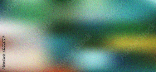 Vibrant abstract grainy gradient texture with soft light transitions in green blue and warm orange hues
