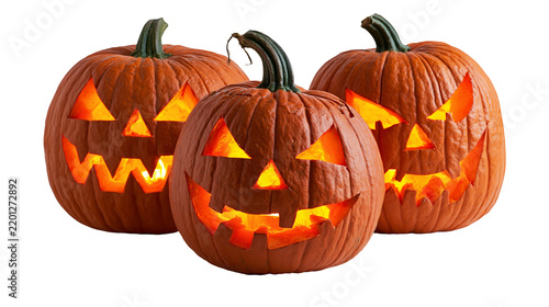 Three glowing carved Halloween jack-o -lantern pumpkins with scary faces