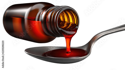 Amber liquid being poured into a spoon from glass bottle