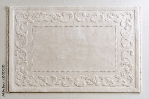 Ornate embossed white decorative frame on textile background