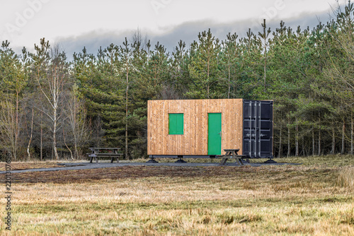 Fotografie Wood-clad converted container unit serving area in community woo