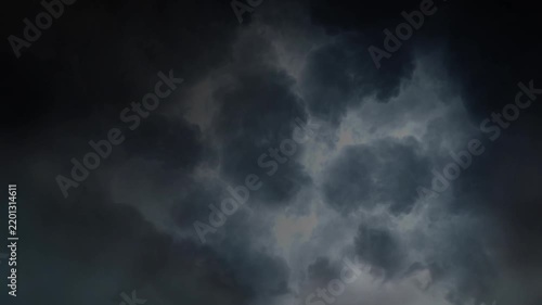 Dark Thunderclouds Illuminated by Distant Lightning