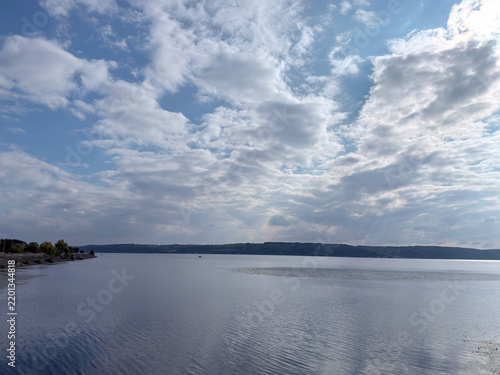 Obraz w ramie Expansive Lake Panorama Beneath Dramatic Cloud Filled Sky