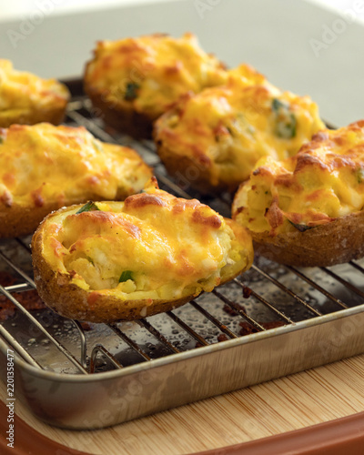 Freshly Baked Loaded Twice-Baked Potatoes with Melted Cheese on a Wire Rack
