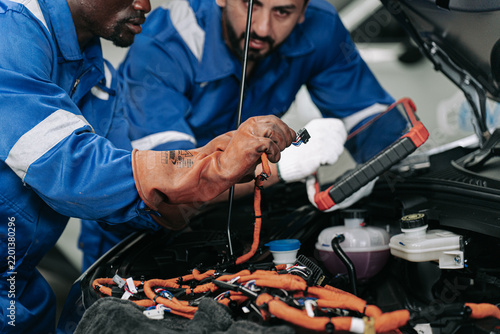 Electric Vehicle Technicians Repairing High Voltage Battery Wiring.