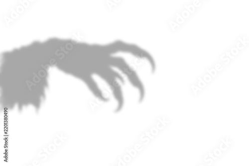 A dark scary shadow of a monster hand with sharp claws reaching out from the side of the frame which isolated on transparent background