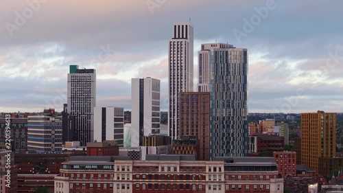 Ambient drone exploration of Leeds, West Yorkshire, England, United Kingdom. Aerial POV of Central City infrastructure, skyscrapers, old town buildings, river and transport in sunset, golden hour.