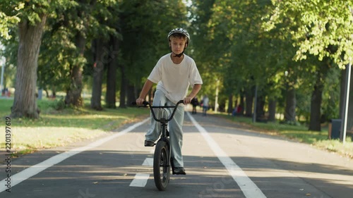 Boy Riding BMX Bicycle on Park Path