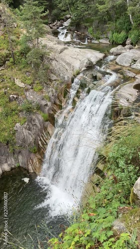 Vertical Mountain Waterfall Dropping Into Rocky Forest Pool