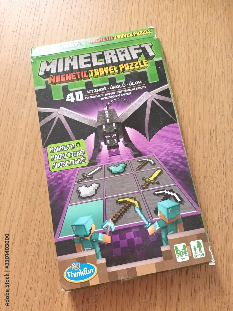 Obraz premium Minecraft magnetic travel puzzle game box featuring an ender dragon and pixelated game items