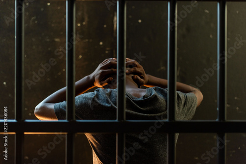 Bild auf Leinwand Person behind bars, feeling trapped.