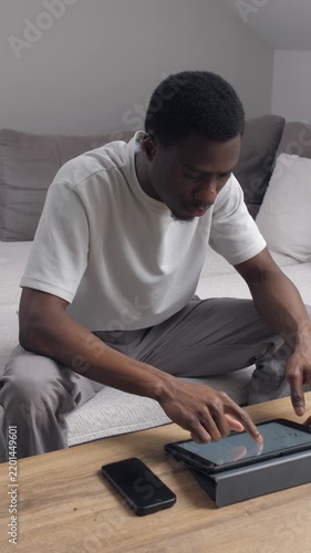 African american man browsing tablet at home
