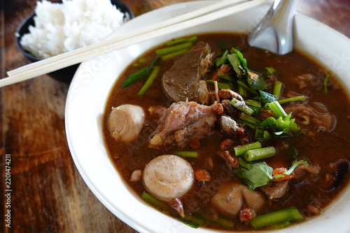 Thai braised beef soup with meatball and offal, served with steamed rice.