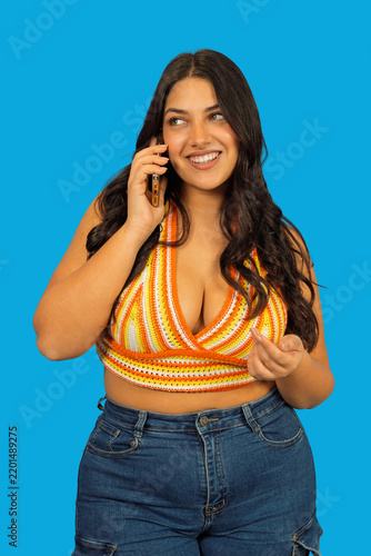 Smiling woman talking on phone with positive expression