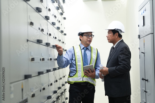 Electrical engineer industrial manager electrical engineer industrial manager discuss control panel in facility