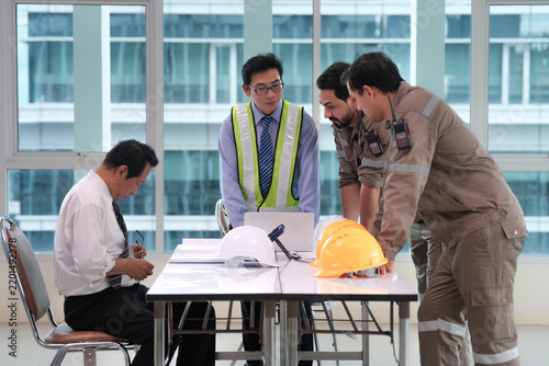 Construction worker safety helmet engineer workplace meeting industrial team discussing project plans