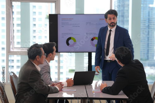 Business presentation office meeting man presenter business team laptop computer data chart boardroom urban office