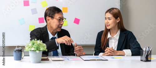 Two people are talking in a business meeting