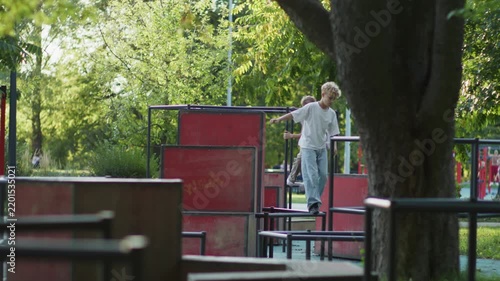 Two Boys Doing Parkour and Jumping on Playground Structures