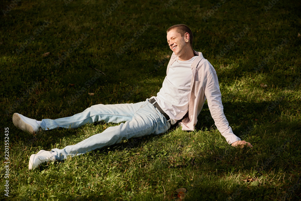 Fototapeta premium Young man enjoys a tranquil moment of mindfulness in a serene park setting