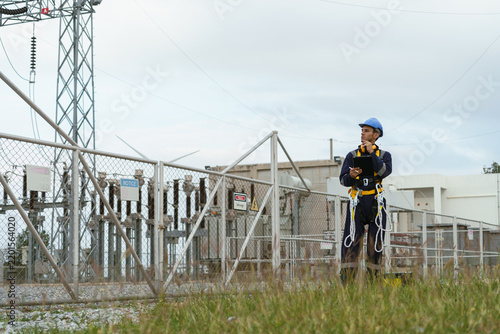 Electrical technicians are inspecting the operation and power distribution system within the substation that receives energy from the wind farm.