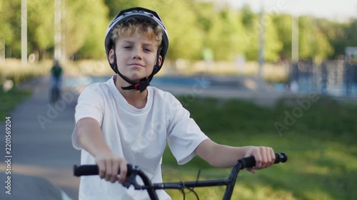 Portrait of 10 Year Old Boy in Helmet Riding BMX Bicycle Outdoors