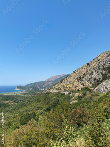 Obraz na plátně Rugged coastal mountains slope down toward the blue Adriatic Sea in Montenegro u