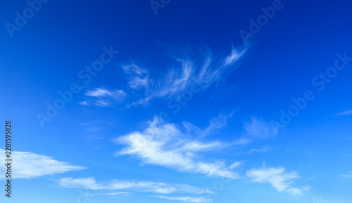 Blue sky with soft white clouds on clear day