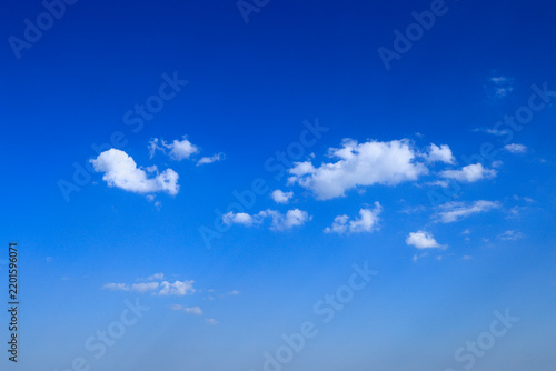 Blue sky with soft white clouds on clear day
