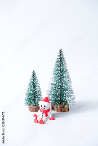 Decorative mini christmas tree with snowman isolated on white background