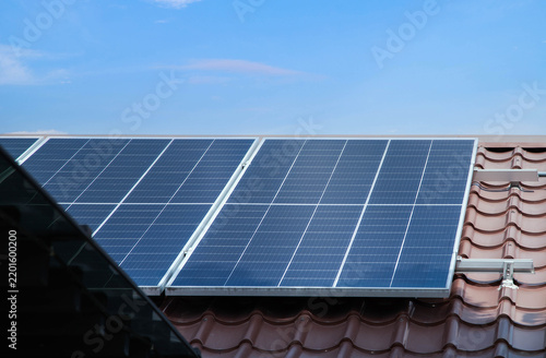 Fotografie Photovoltaic solar power panel on blue sky ,green clean alternative energy