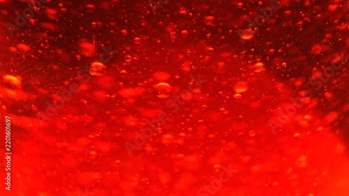 Close Up of Floating Red Bubbles in Lava Lamp, Vibrant Abstract Liquid Texture with Hypnotic Motion