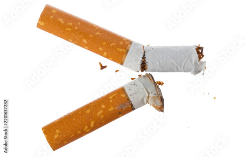 Картината върху платно Broken cigarette lying on a white surface showing the tobacco inside
