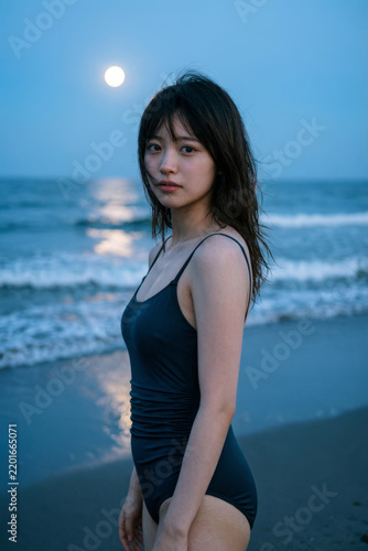 Portrait of an Asian girl on the seashore on a moonlit night.
