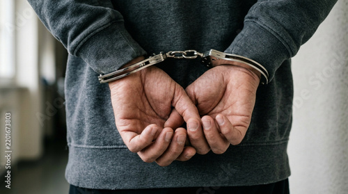 Suspect Handcuffed Behind Back, Arrested and Detained, Crime and Justice Concept