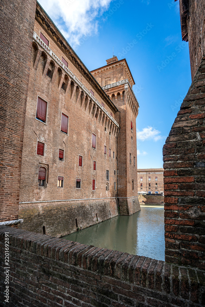 Obraz premium Walls and tower of Castello Estense in Ferrara framed by a brick parapet