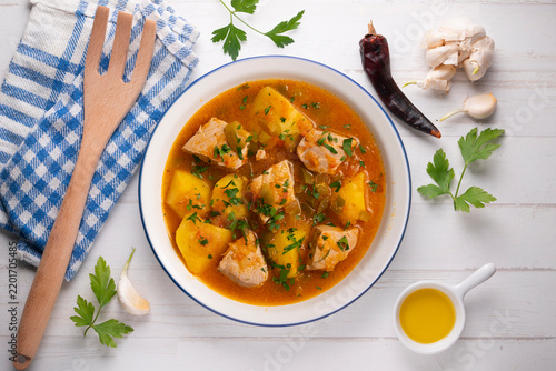 Traditional Basque tuna stew with potatoes served on a festive holiday table setting. Marmitako de atún.