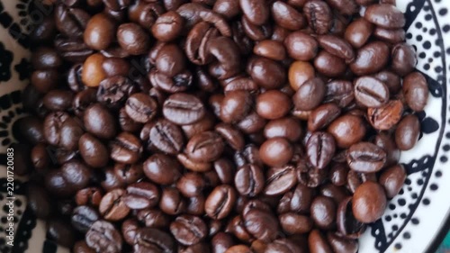 Coffee beans in a ceramic bowl. 