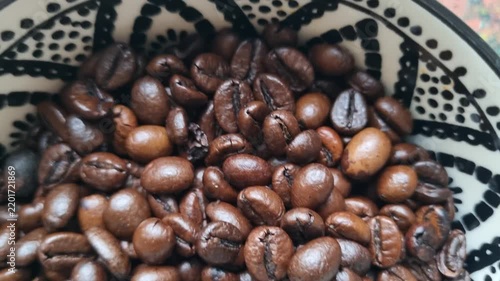 Coffee beans in a ceramic bowl. 