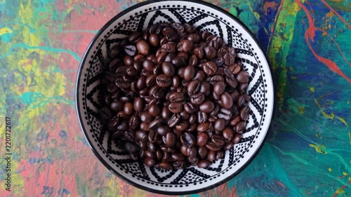 Coffee beans in a ceramic bowl. 