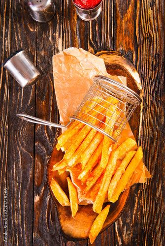 Crisp golden brown curly fried potato with rich red tomato dipping sauce close-up for snack or appetizer