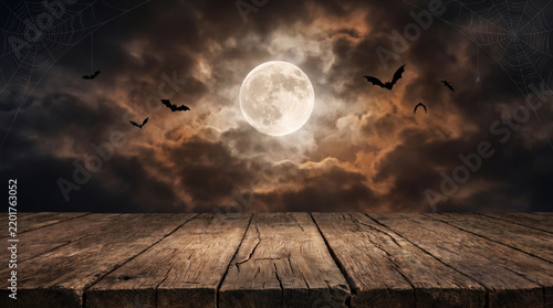 Moonlit halloween tabletop background with bat silhouette and rustic wooden surface. Horror ghost party celebration. mysterious occult cosy, topview composition invitation copy space