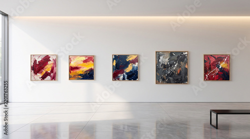 Art gallery exhibits colorful abstract paintings along bright white minimalist walls.