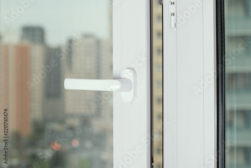 View from window of living room to outside on city houses